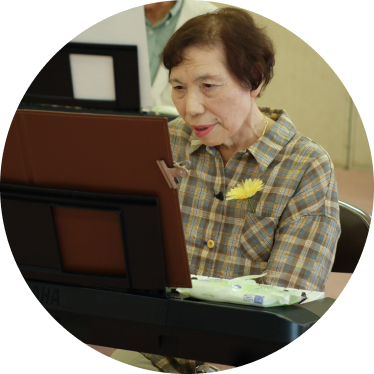 ピアノのレッスンを受けるシニア女性